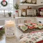 Load image into Gallery viewer, A lit hand poured candle labeled Christmas Cookie sits on a kitchen counter beside decorated holiday cookies on a cooling rack, with an oven mitt and a cozy kitchen background. Southern Charm Farmhouse.
