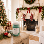 Load image into Gallery viewer, Christmas Tree candle near a bright cream fireplace decorated with evergreen garland, red bows, stockings and a Christmas tree. Southern Charm Farmhouse.
