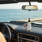 Load image into Gallery viewer, Car interior with a car perfume bottle on the dashboard and a 4 oz Room Spray bottle, overlooking a scenic view. Southern Charm Farmhouse.
