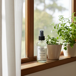 Load image into Gallery viewer, 4 oz Bottle of Pink Sugar Linen Spray on a windowsill with plants. Southern Charm Farmhouse.
