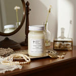 Load image into Gallery viewer, 16 oz Mason Jar hand poured 'Sweet Grace' candle on a wood vanity with pearls and decorative items. Southern Charm Farmhouse.
