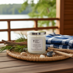 Load image into Gallery viewer, 2 wick hand poured Candle labeled 'Lakeside Cabin' on a woven tray with natural elements on a wooden deck. Southern Charm Farmhouse.

