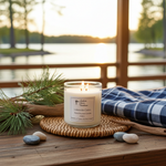 Load image into Gallery viewer, 2 wick hand poured lit Candle on a woven coaster with a scenic view of a lake in the background. Southern Charm Farmhouse.
