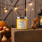 Load image into Gallery viewer, Yellow hand poured candle labeled 'Mulled Cider Press' on a wooden surface with pumpkins, apples, and a lantern in the background. Southern Charm Farmhouse.
