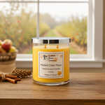 Load image into Gallery viewer, Hand poured Candle labeled 'Mulled Cider Press' on a wooden surface with a window view of apples in the background. Southern Charm Farmhouse.
