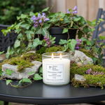Load image into Gallery viewer, Midsummer's Night 2 Wick hand pouted Candle with a label on a table surrounded by plants and rocks. Southern Charm Farmhouse.
