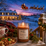 Load image into Gallery viewer, A lit jar candle labeled 'Reindeer Munch'  sits on a rustic wooden table in a cozy holiday outdoor scene. The candle is surrounded by a mug, pretzels, marshmallows, pinecones, and evergreen branches, with a snowy village and Santa in a sleigh visible in the background at dusk. Southern Charm Farmhouse.
