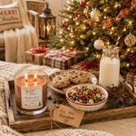 Load image into Gallery viewer, A cozy holiday tabletop scene with a lit candle labeled 'For the Reindeer' on a wooden tray beside cookies, cereal, milk, wrapped gifts, and a decorated Christmas tree in a warmly lit living room. 2 wick hand poured candle label reads Reindeer Munch.  Southern Charm Farmhouse
