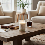 Load image into Gallery viewer, 16 oz hand poured Mason jar Santal 33 lit Candle and glass of coffee on a wooden table in a cozy living room. Southern Charm Farmhouse.
