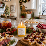 Load image into Gallery viewer, A lit yellow hand poured scented candle labeled 'Spiced Holiday Cider' sits on a decorated holiday kitchen table surrounded by food, glasses, cranberry garnishes, and festive garlands. Southern Charm Farmhouse.
