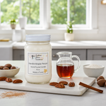 Load image into Gallery viewer, 16 oz mason Jar of vanilla maple pecan hand poured candle on a kitchen counter with a pitcher of liquid and pecans.  Southern Charm Farmhouse.
